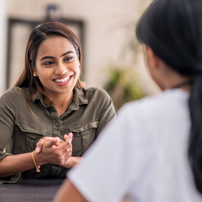 a smiling woman consulting with a physician