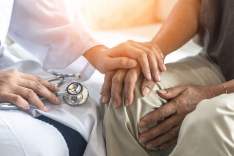 Doctor holding a patients hand