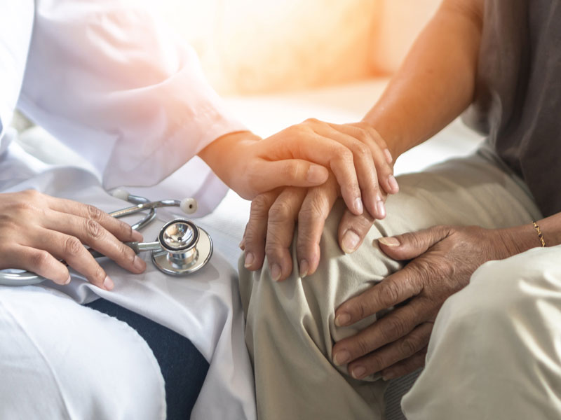 Doctor holding a patients hand